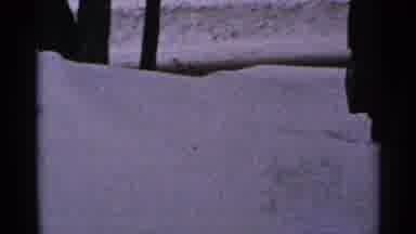 Minnesota USA-1965: A Man Walking Through The Snow With His Briefcase In His Hand