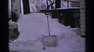 Minnesota USA-1965: Snow Drifts And Shovel Standing In Winter Yard