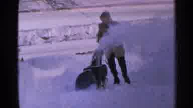 Minnesota USA (1965): A Man Pushing A Machine To Help Him Get Rid Of The Snow On