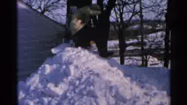 Minnesota USA (1965): Person On Top Of A Snow Pile About To Throw Snow Towards The