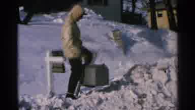 Minnesota USA (1965): A Man Going Outside In Snow And Sitting On Top Of A Mailbox