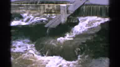 Minnesota USA (1965): Swift Flowing Water Overwhelms A Damn And Floods A Nearby