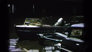 Minnesota USA (1965): Fire Hose Draining Something As Boat Floats Freely In The