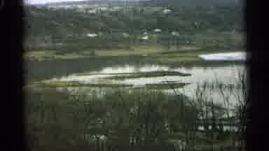 Minnesota USA (1965): Close-Up On Flowing Water And A Distant Shot Of A Forest Or