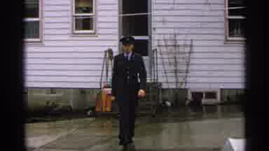 Minnesota USA (1965): Man Wearing Uniform Walking Towards Camera Following A