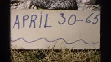 Minnesota USA (1965): A Sign Labeled April 30-65 Lays Propped On A Rock On The