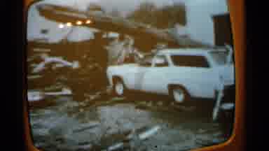 Minnesota USA (1965): People Removing Debris From White Car On A Cloudy Day