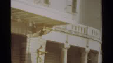 NAZARE PORTUGAL-1965: A Sunlit Street With Traditional Houses And Balconies