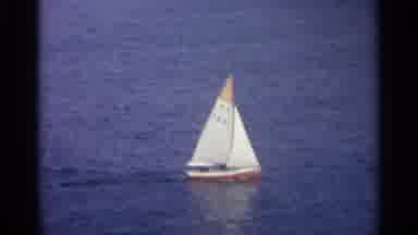 Sicily-1965: Sailboat Gliding Across Ocean With Coastal Town View
