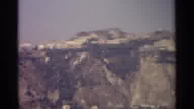 Sicily-1965: A High Mountain Beside A Beach That Overlooks A Lake