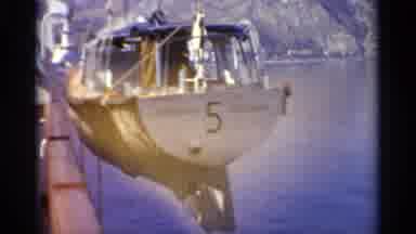 Sicily-1965: Grey Lifeboat And Rocky Island On A Clear Sunny Day
