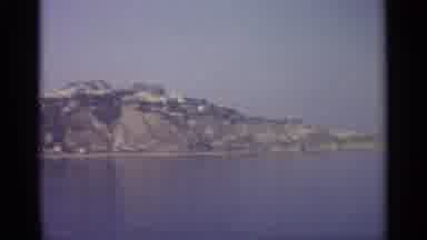 Sicily-1965: Scenic Mountain Coastline Across Calm Waters Under Foggy Sky