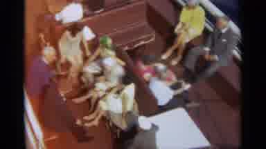 STOCKHOLM SWEDEN-1965: Camera Pans Across Passengers Sitting on Boat Deck Crossing Blue Water