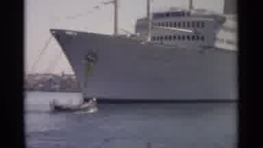 TANGIER MOROCCO-1965: Camera Pans Across Large White Ship As People Pass By