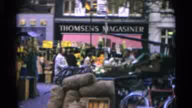 Copenhagen Denmark-1966: People Shop At An Outdoor Produce Market In A City