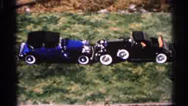 Hamel Minnesota (1966): A Blue And A Black Car In The Grass Facing One Another