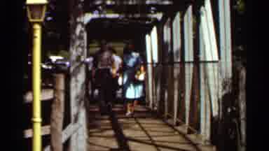 Saint Louis Missouri (1966): Two People Walking Underneath A White Metal Structure