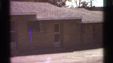 Saint Louis Missouri (1966): A Man Is Shown Walking In Front Of A Small Brown Home