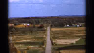 Sauk Centre Minnesota (1966): Green Fields And Red Fall Trees On A Sunny Day