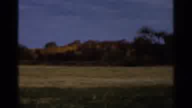 Sauk Centre Minnesota (1966): Landscape Of A Vast Green Field With A Forest In The