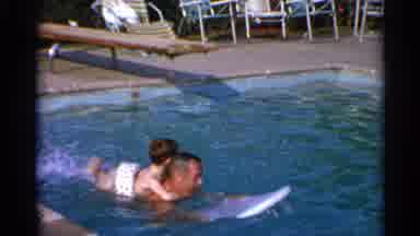 US Virgin Islands (1966): Man Swimming In A Pool With A Child Holding Onto His