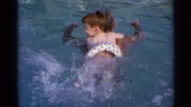 US Virgin Islands (1966): An Young Boy In A Floating Ring Rides On The Back Of A