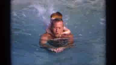US Virgin Islands (1966): A Father Swims Through The Water With His Small Son On