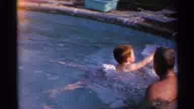 US Virgin Islands (1966): Children Learning How To Swim With Their Father In A