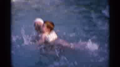 US Virgin Islands (1966): A Child Wearing A Floating Device Holds On To A Woman In