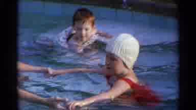 US Virgin Islands (1966): A Young Boy Floats In A Swimming Pool While A Girl In A
