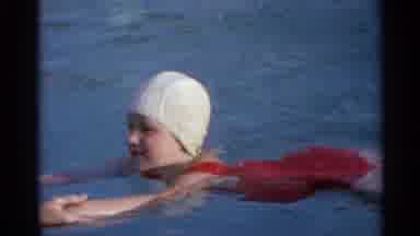 US Virgin Islands (1966): A Woman Helping A Young Girl Swim With Swim Caps On