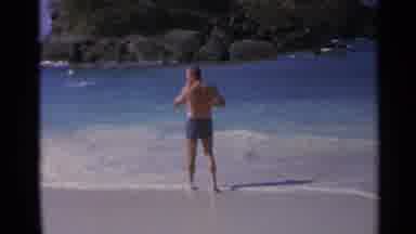 US Virgin Islands (1967): Man In His Swim Shorts Standing On The Beach Walk Toward