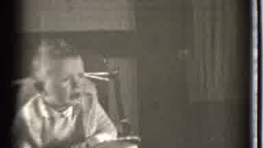 Danielson Connecticut (1939): A Perplexed Child On A High Chair Indicating