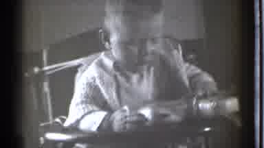 Danielson Connecticut (1939): Baby In High Chair Playing With A Toy That Keeps