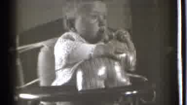 Danielson Connecticut (1939): Baby Sitting Up In A High Chair Holding Onto A Toy