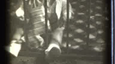 Danielson Connecticut (1939): A Baby Grasping The Metal Bar In Front Of It With