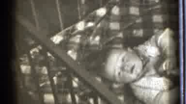 Danielson Connecticut (1939): Baby Crying In A Crib With Checked Sheets While
