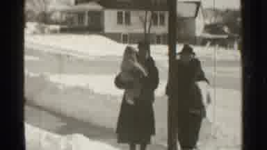 Danielson Connecticut (1939): A Couple Walks With Their Child On The Street