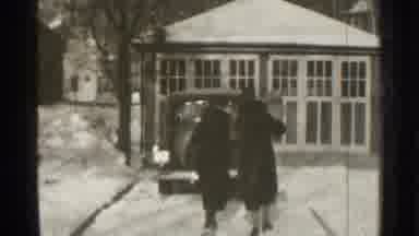 Danielson Connecticut (1939): Two People Wearing Black Coats Walk To Parked Black