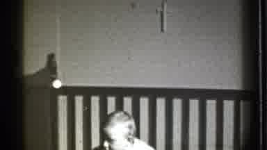 Danielson Connecticut (1939): A Baby Sits In His Crib With A Cross Hanging Over