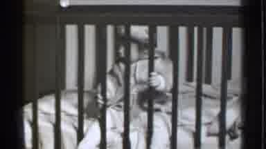 Danielson Connecticut (1939): Baby Awake In Bed Having Fun Swinging His Legs Awake