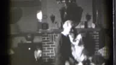 Danielson Connecticut (1939): A Group Of People Walking Around A Room In Front Of