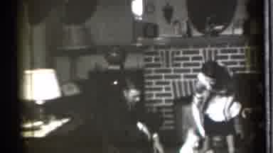 Danielson Connecticut (1939): A Group Of People Walking Around A Living Room