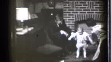 Danielson Connecticut (1939): Parents Help Their Young Child Stand Up In Front Of