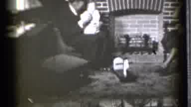 Danielson Connecticut (1939): Man Wearing Glasses Holds Baby While Sitting Next To