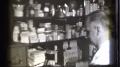 Danielson Connecticut (1939): An Old Pharmacist Organizing His Various Medicines