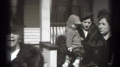 New York (1939): Woman Wearing Fur Cot Carries Toddler To Black Car On Sunny Day