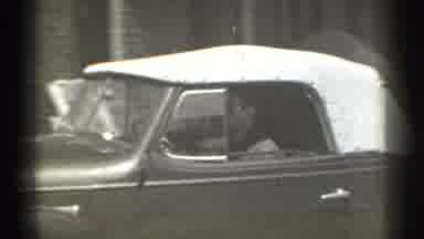 New York (1939): Man Driving Car With Convertible White Top Turning Northerner
