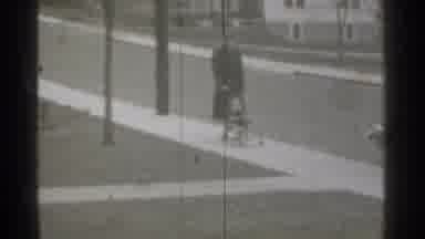 New York (1939): Person Walking Backwards Down Sidewalk Pulling Stroller With Him