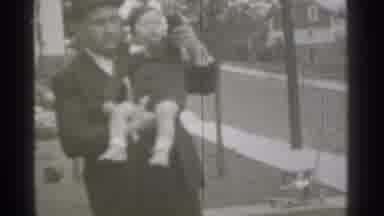 New York (1939): Adult Man Holding Child And Helping M To Wave